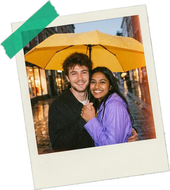 Polaroid photo of a couple sharing a yellow umbrella in the rain