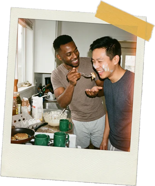 Polaroid photo of a couple cooking and tasting food together in the kitchen